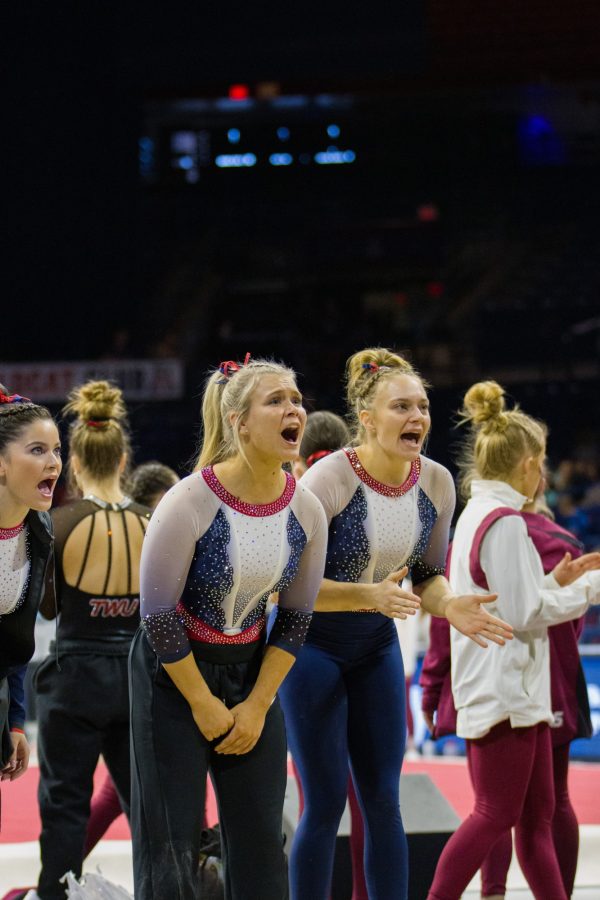  Indigo Morgan and Lara Burhans cheer on their teammates at a Quad Meet versus Illinois, Texas Womens and Bowling Green on Jan 14 at McKale Stadium. The Wildcats went on to win the meet with a score of 195.825. 