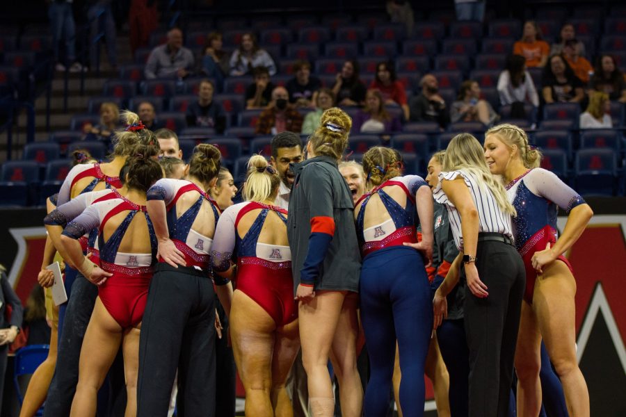 The University of Arizona Gymnastics team huddles at a Quad Meet versus Illinois, Texas Womens and Bowling Green on Jan 14 at McKale Stadium. The Wildcats went on to win the meet with a score of 195.825. 