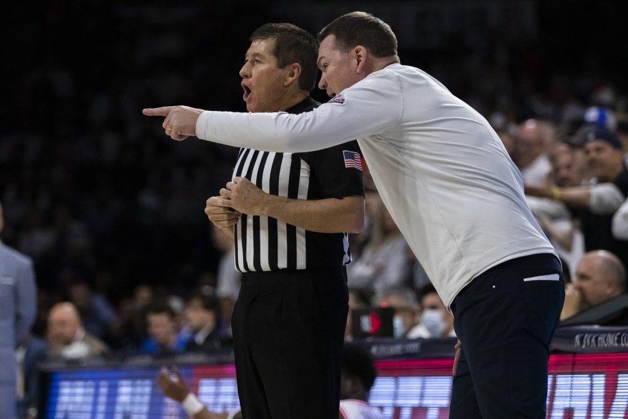Arizona men’s basketball team  head coach Tommy Lloyd talks to a referee on Jan. 21 in McKale Center. The Wildcats went on to win against UCLA with a score of 58-52.