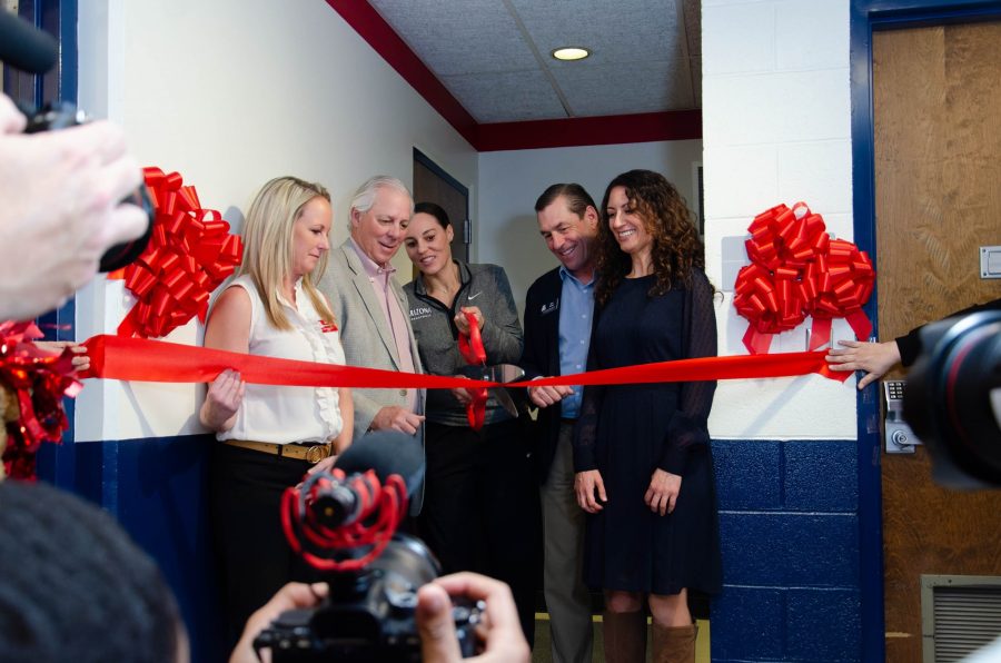 Adia+Barnes+cuts+the+ribbon+of+the+brand+new+McKale+lactation+room+with+staff+and+President+Dr.+Robert+C.+Robbins+Tuesday%2C+Feb.+7+inside+McKale+Memorial+Center.+The+lactation+room+is+now+open+to+all+visitors+of+McKale+Memorial+Center.