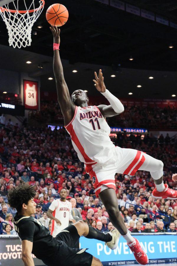 Wildcat Oumar Ballo (11) flys through the air while shooting the ball at the game against the University of Colorado in McKale Memorial Center on Feb. 18. the Wildcats beat the University of Colorado 68-78.