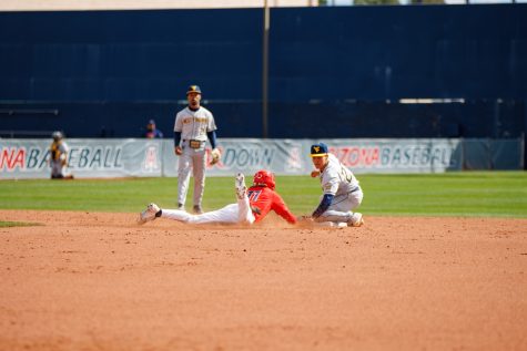 Arizona shortstop Nik McClaughry slides into second in a game against West Virginia on Feb. 26 at Hi Corbett Field. The Wildcats went on to win the game 15-5. 