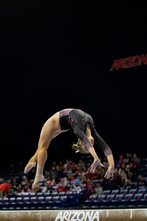 Wildcat Alysen Fears competes on the beam in a meet against the University of Washington on Feb. 10 at McKale Center. The Wildcats went on to win the meet by .05 points with a score of 196.800. 