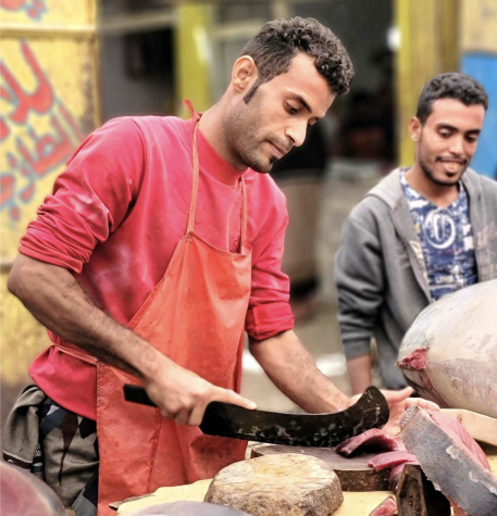 Vendors sell fish as customers feast in the Almarkeze Market in Taiz, Yemen, on February 10, 2023. 