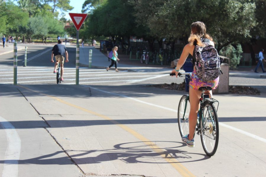 A University of Arizona student bikes toward Old Main on Sept. 21, 2018. The schools offers students, staff and community members several bike services on campus.