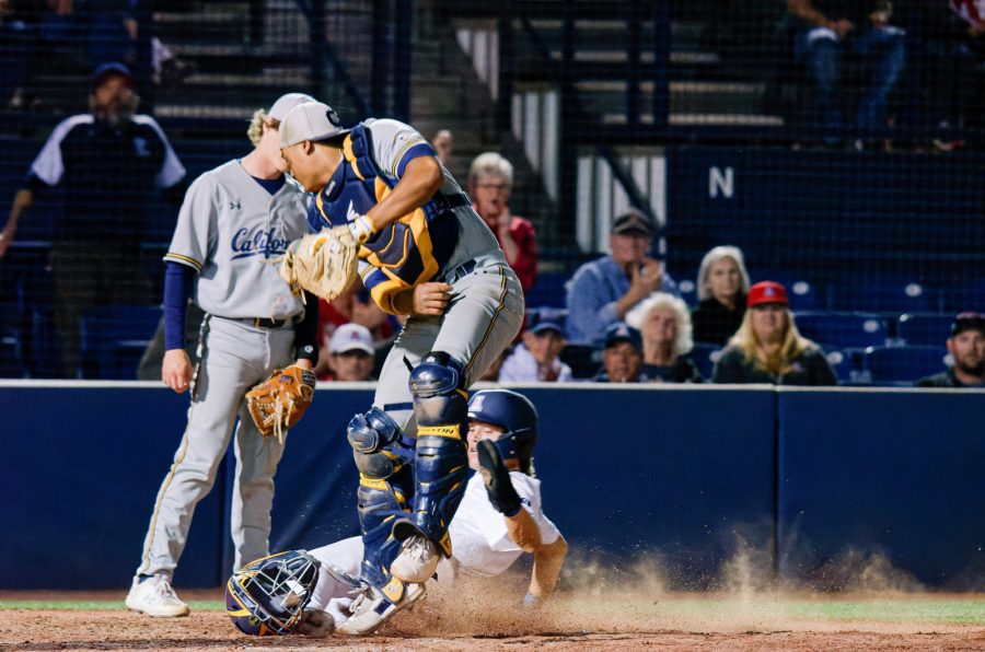 Nik McClaughry slides safely into home base during a game against California Friday, March 10 at Hi Corbett Field. Wildcats took the win 13-2. 