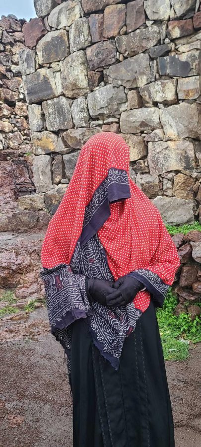 Women carry a torah covered in a red scarf to a wedding on May 31, 2023 in Dhamar, Jabal Al Sharq District, Yemen. This is an old custom in the northern regions when guests go to the wedding of a close relative or even a friend. The woman goes to carry the torah, which is a gift for the wedding with sweets and popular foods inside. The red scarf covered by the Torah is a tradition for women to wear when going out.