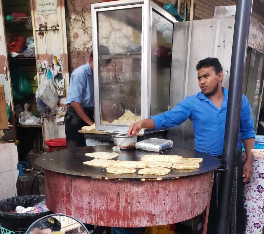 A baker sells motabqiah in Taiz, Yemen on Monday, Feb. 13, 2023, to provide for his family. Motabaqiah is a type of bread that working people often eat for lunch because it is more affordable.