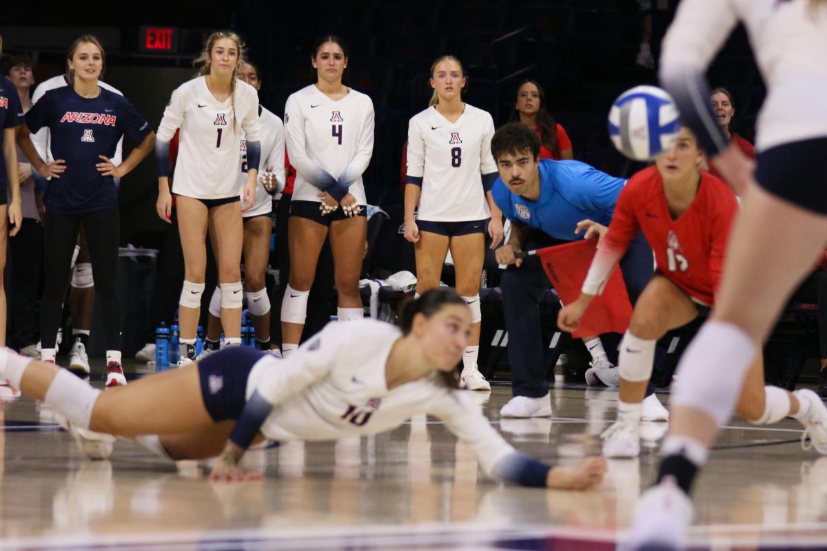 Puk Stubbe makes an athletic save as the team watches on in their win against Pacific on Aug. 26, 2023 at McKale Center.