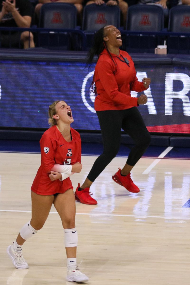 Joy Valles and Head Coach Charita Stubbs celebrate a hard fought point against Pacific at McKale Center on Aug. on 26, 2023.