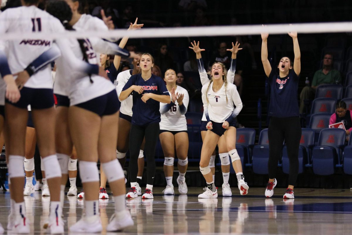 Puk+Stubbe+makes+an+athletic+save+as+the+team+watches+on+in+their+win+against+Pacific+on+Aug.+26%2C+2023+at+McKale+Center.