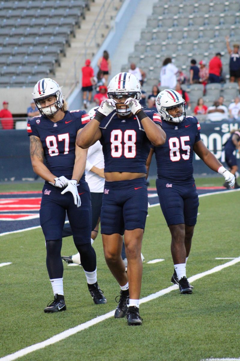 Tyler Powell (87), Keyan Burnett (88) and Roberto Miranda (85) get geared up for the first home football game of the season. The Wildcats secured a 38-3 win against NAU.