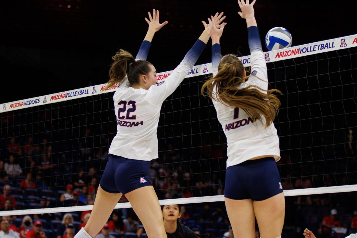 Nicole Briggs (22) and Ana Heath (7) block the ball in a game against New Mexico State on Friday, Sept. 15 at McKale Center. The Wildcats won the game 3-1.
