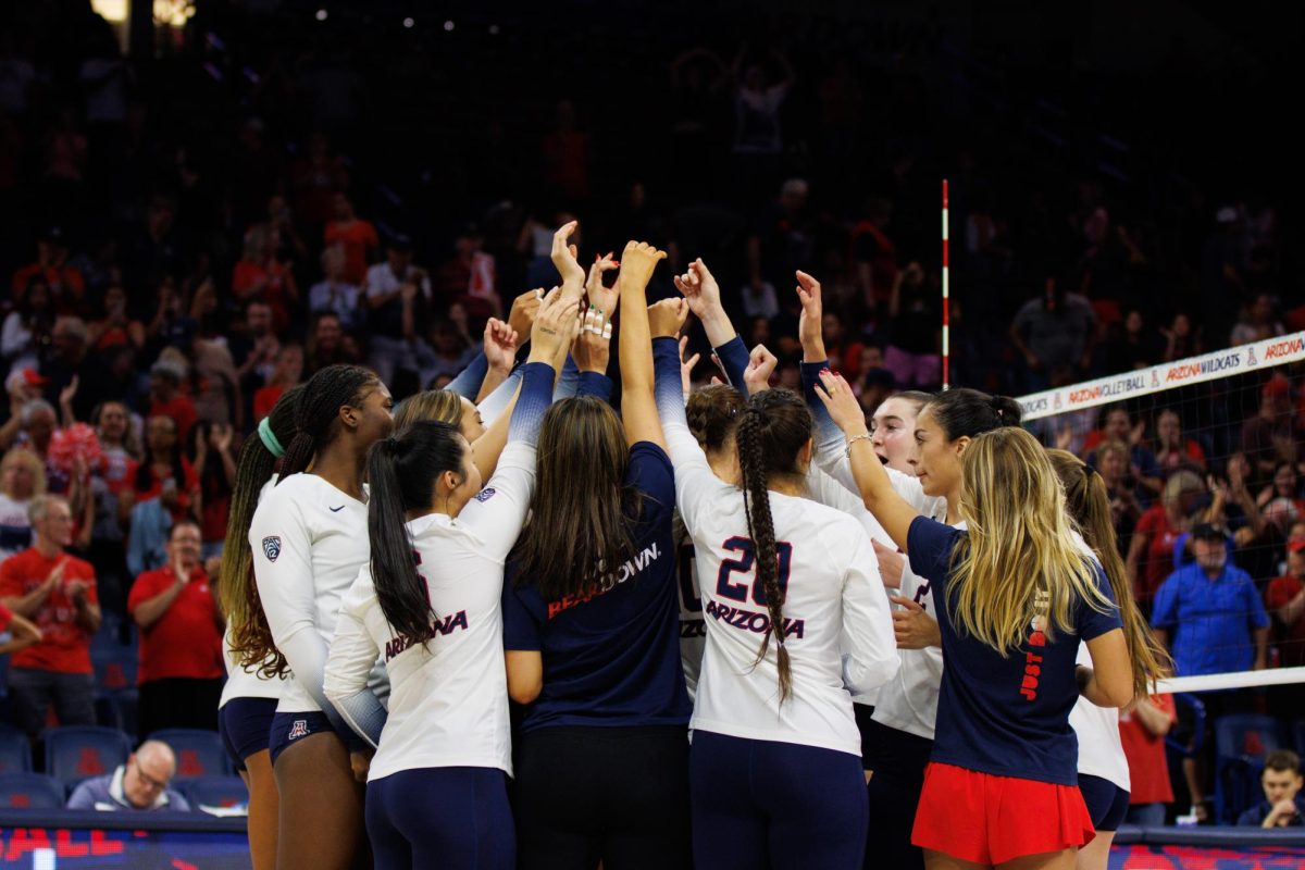 The Arizona volleyball team celebrates a win against New Mexico State University on Friday, Sept. 15, in McKale Center. The Wildcats won the game 3-1.