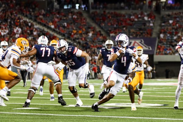 Arizona football wide receiver Tetairoa McMillan (4) makes a cut while running with the ball in his hands in a game against the University of Texas at El Paso on Saturday, Sept. 16. Arizona won the game 31-10.