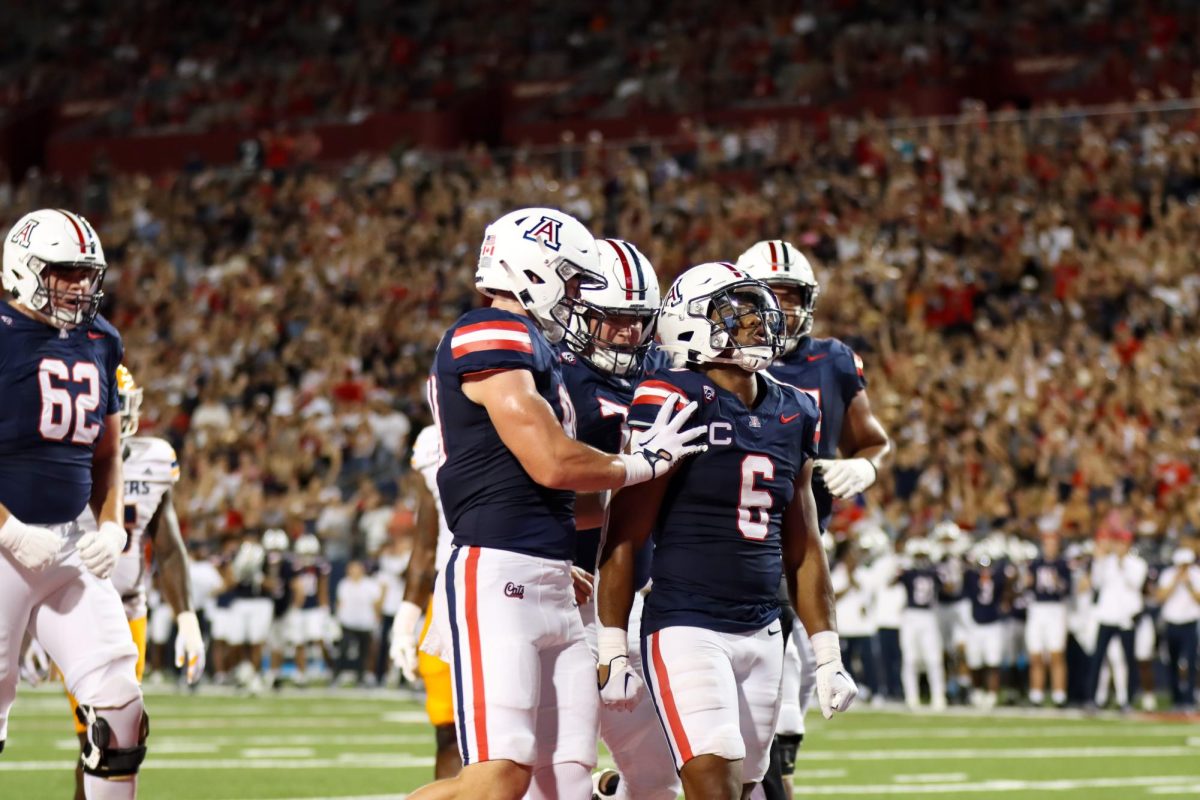 Arizona football running back Michael Wiley (6) gets praise from his teammates during a game against the University of Texas at El Paso on Saturday, Sept. 16. Arizona won the game 31-10.