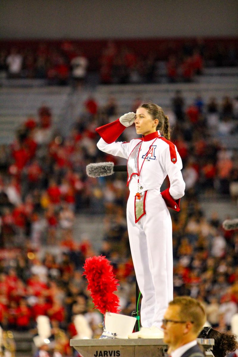 A Pride of Arizona drum major leads the band as they perform at UA Footballs first game of the season on Sept. 2, 2023. The night ended in a win for UA with a score of 38-3. player catches a pass on the offense. In their first game of the season, the UA secured a 38-3 win.