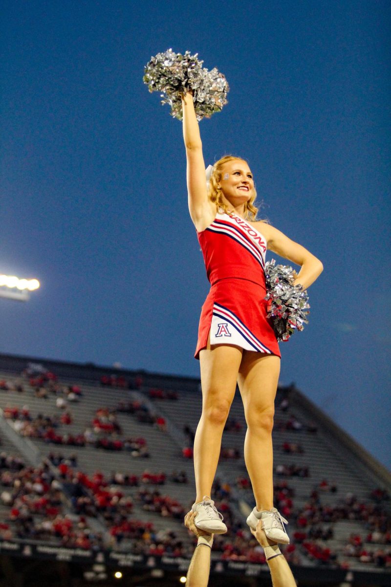 UA flyer, Elizabeth B, hypes the crowd with the UA cheerleading team on Sept. 2, 2023. The night ended in a successful 38-3 win for the Wildcats.