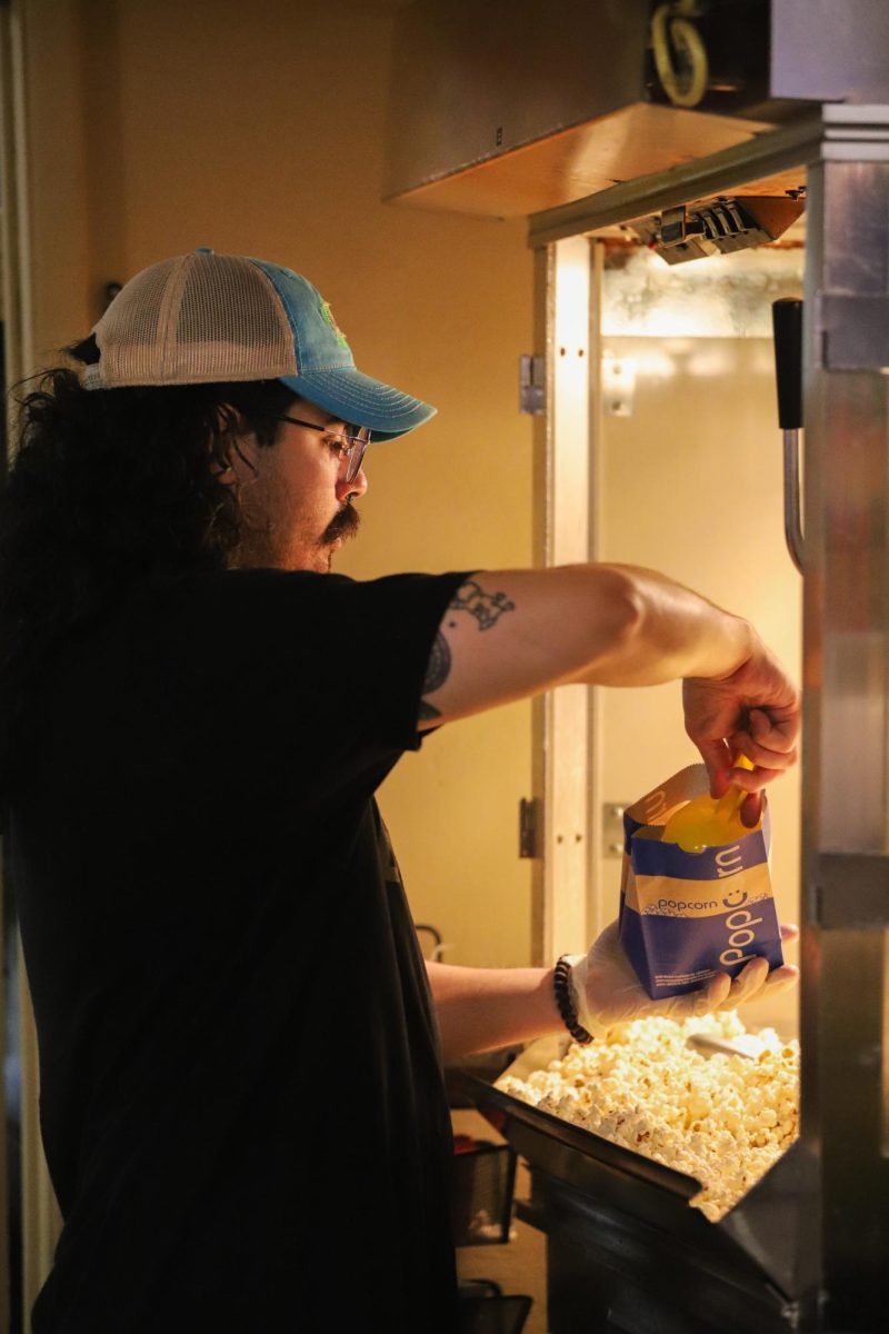 A Loft Cinema employee prepares popcorn for the premiere screening of The Lords of Cornhole on Sept. 10. The movie was created entirely in Tucson.
