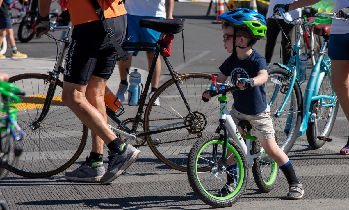 A+child+rides+his+bike+for+Cyclovia+on+Oct.+29.+During+the+event%2C+certain+roads+were+closed+for+pedestrians+and+bikers+to+freely+ride.