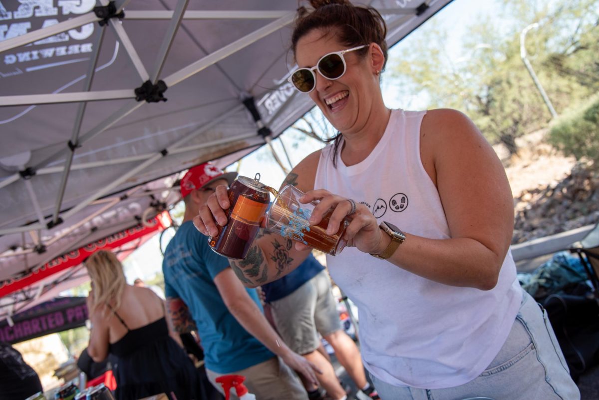 A+local+barista+pours+a+handcrafted+product+from+Grand+Canyon+Brewing+and+Distillery+on+Sept.+30.+The+distillery+was+one+of+the+many+vendors+at+the+annual+Oktoberfest.%0A