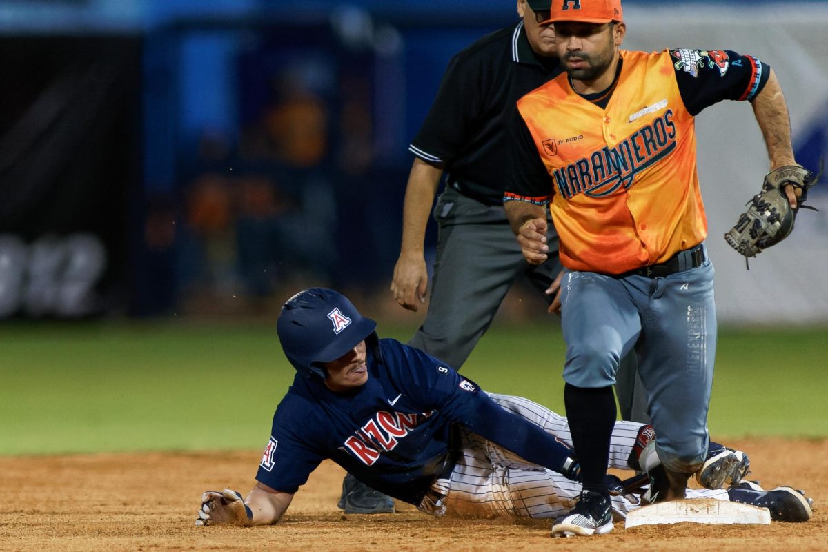 Garen Caulfield slides back into first base mid-game against Hermosillo’s Naranjeros during the Mexican Baseball Fiesta on Oct. 5 at Kino Veterans Memorial Stadium. The Wildcats won the game 3-1.