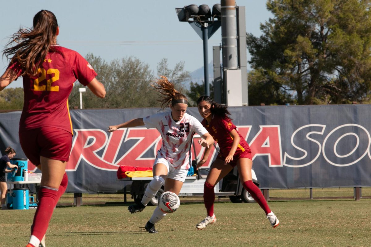 Nicole Dallin (23) of the Arizona Wildcats dribbles while defender Alyssa Gonzalez attempts to defend during their match at Murphey Field at Mulcahy Soccer Stadium in Tucson on Oct. 22. USCs aggressive defense led to the game concluding with a 1-1 tie.
