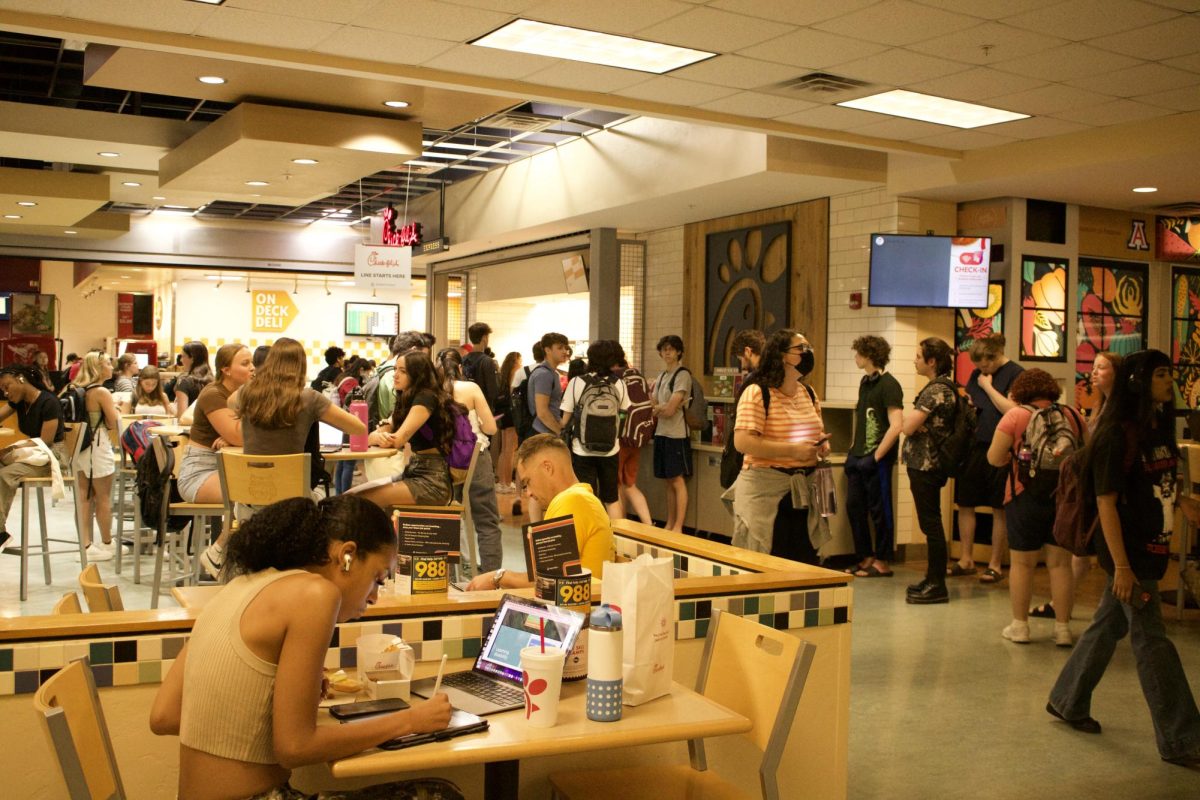 Students study and eat in the student union in Spring 2023. Restaurants such as Chick-fil-A, Panda Express and IQ Fresh are available options. 