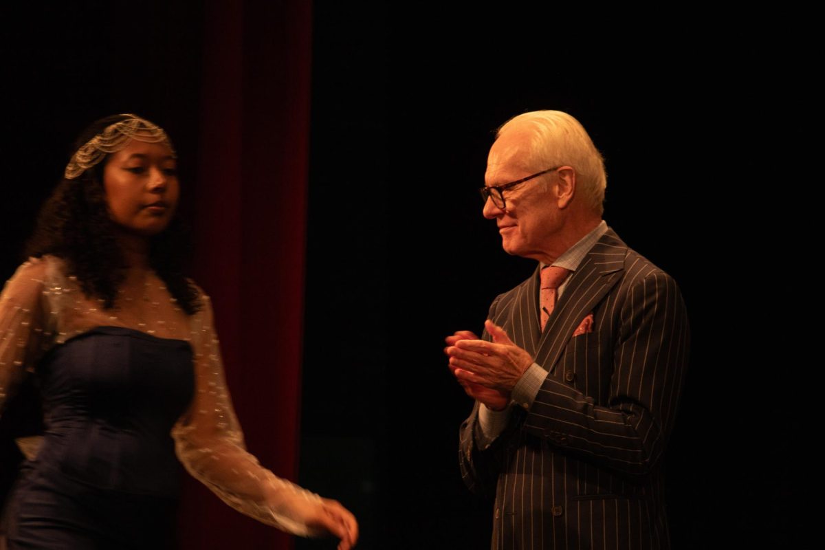 Tim+Gunn+gives+designers+and+their+models+a+final+applause+at+the+Poetry+of+Fashion+event+in+Centennial+Hall+on+Oct.+11.+The+poetry+used+to+motivate+these+looks+were+excerpts+from+translated+pieces+written+in+languages+taught+in+the+College+of+Humanities.