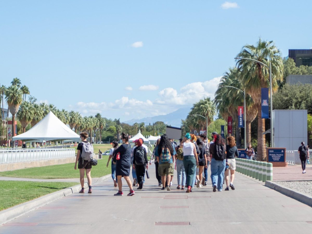 A group of protestors walk at the National Student Walkout on the Mall on the University of Arizona Campus on Oct 25. The group walked around during the Housing Fair.