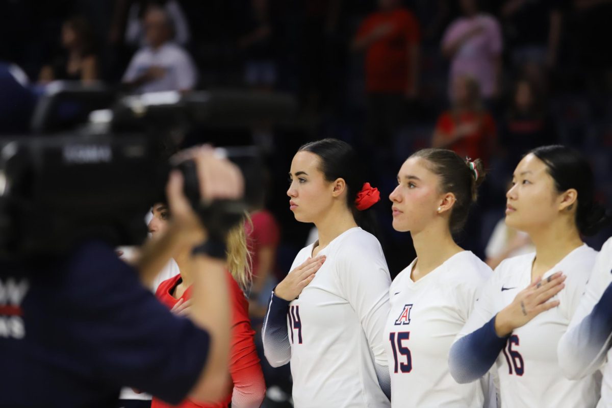 Ava+Tortorello+and+the+Arizona+volleyball+team+stands+for+the+anthem+before+their+home+matchup+against+USC+on+Sunday%2C+Oct.+8%2C+in+McKale+Center.+The+team+won+the+first+and+fourth+sets+in+a+3-2+loss.%0A