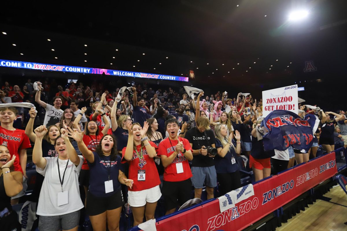 The ZonaZoo celebrates a set win against USC in the home volleyball match in McKale Center on Sunday, Oct. 8. Arizona lost to USC 3-2.