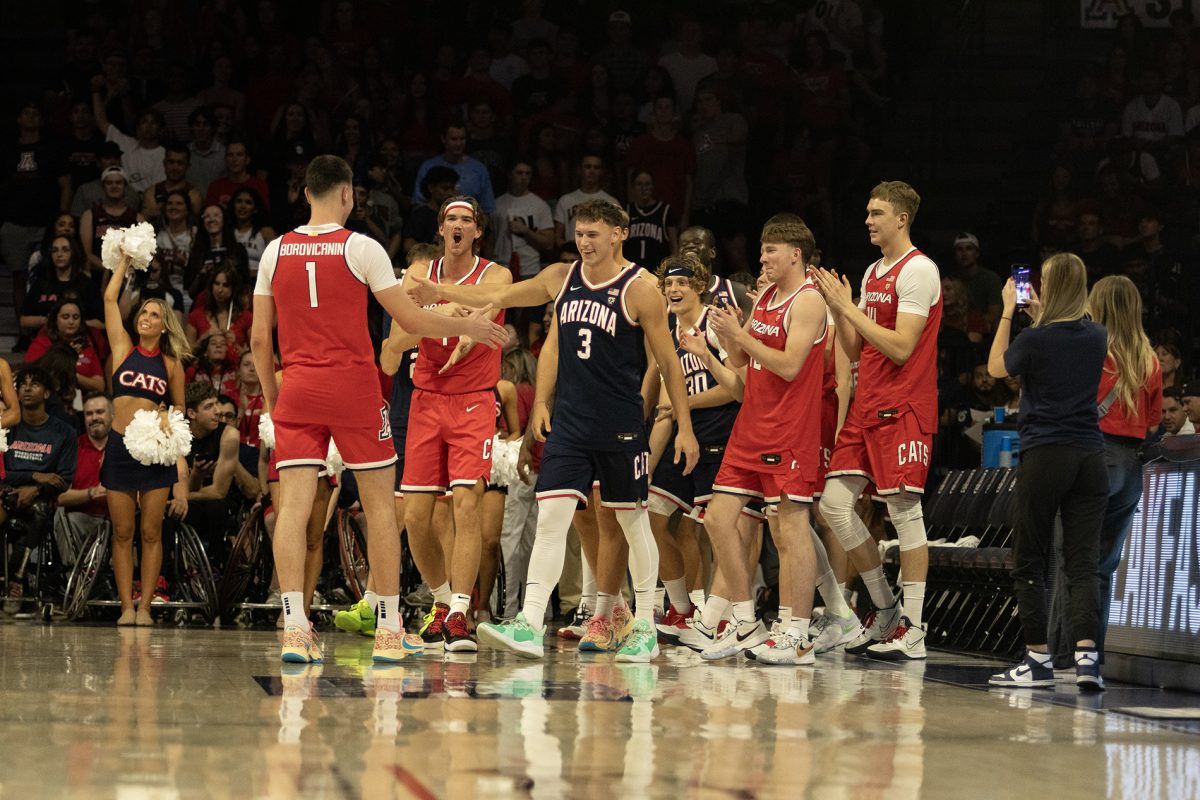 The Arizona men’s basketball team celebrates Filip Borovicanins (1) win for the 3-point contest at the Red and Blue game on Sept. 29 in McKale Center. Borovicanin is a sophomore forward from Belgrade, Serbia.