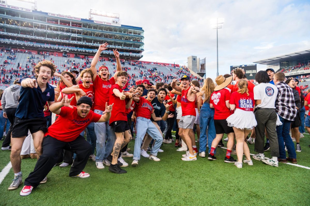 Wildcats fans rush the field to celebrate the football teams victory at Arizona Stadium on Nov. 18. The Wildcats beat University of Utah 42-18.
