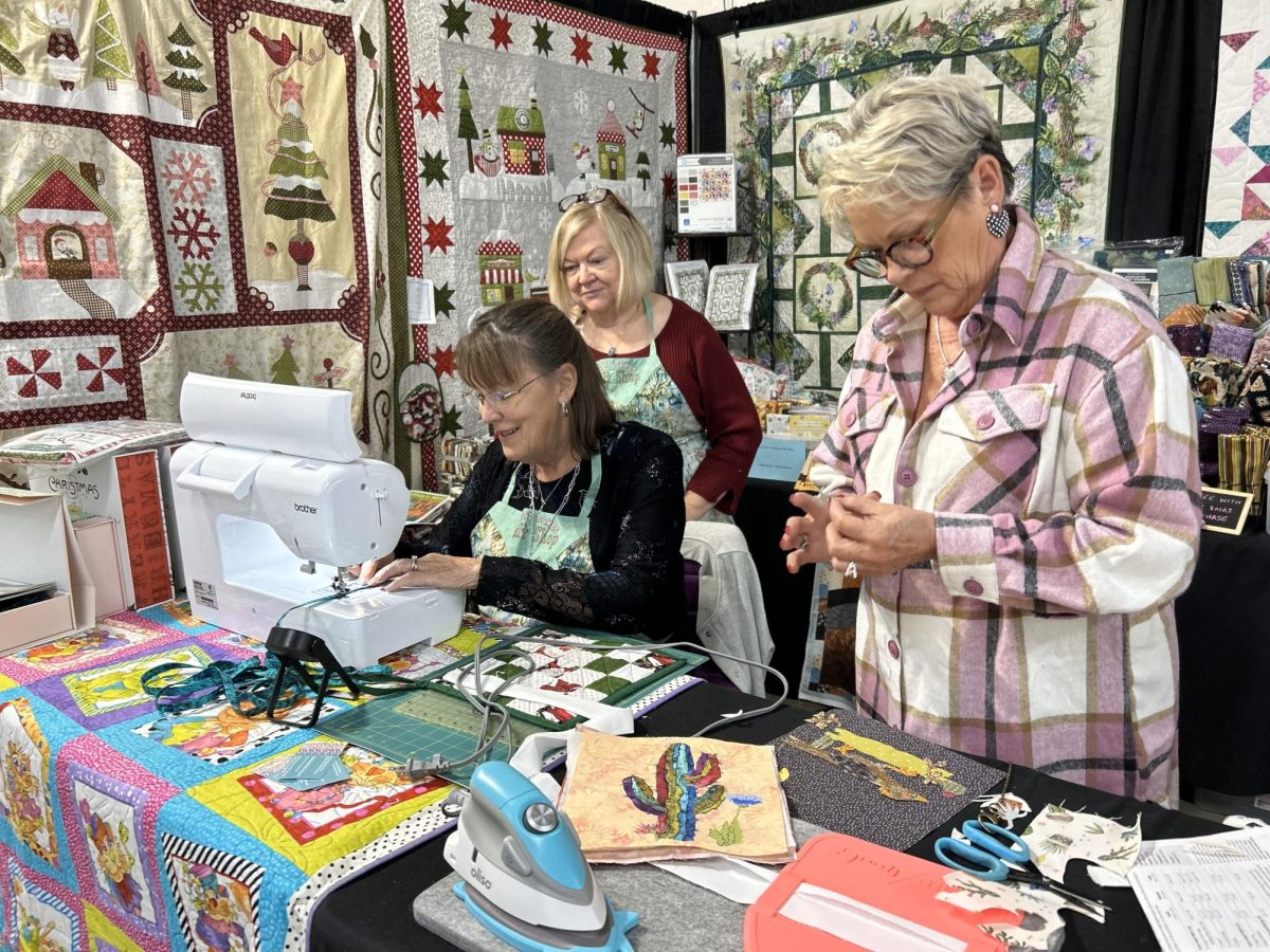 Patti Sherwin (left, in red) is owner of Patti Cakes Quilt Shop at the Quilt, Craft & Sewing Festival at the Tucson Expo Center on Nov. 10. Patti Cakes Quilt Shop is located in Bullhead, Ariz. and has an Etsy shop.
