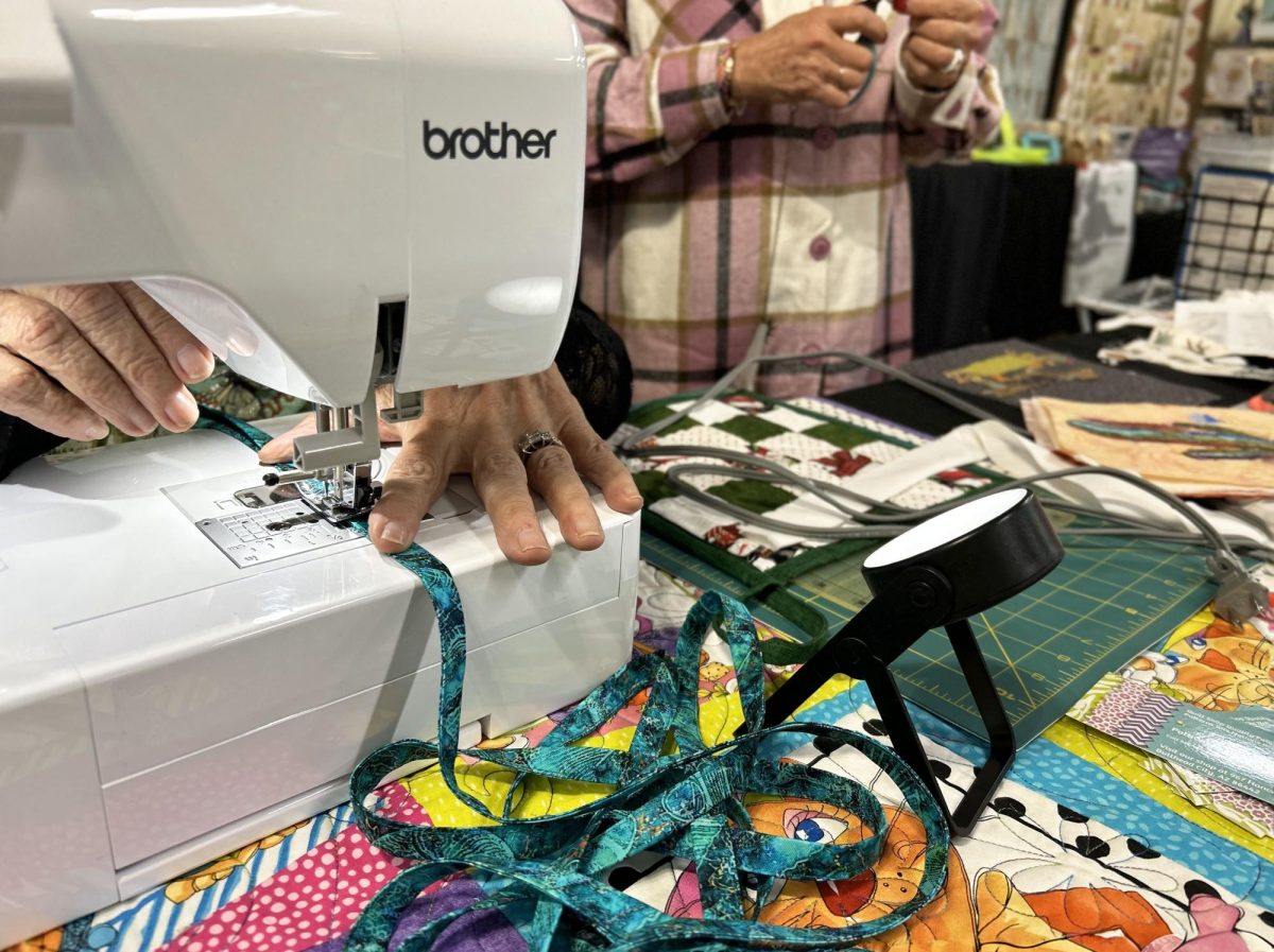 Patti Cakes Quilt Shop sewers work on projects during the Quilt, Craft & Sewing Festival at the Tucson Expo Center on Nov. 10. The projects being made were a tote bag and layered designs with fabric.
