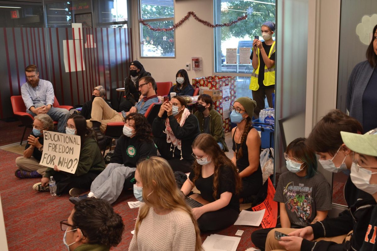 University of Arizona students and community members held a sit-in at the College of Education Monday to protest the suspension of two university professors. Those involved in the sit-in demanded the immediate reinstatement of the professors. 