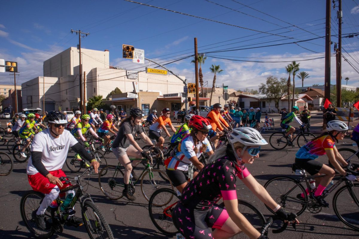 Cyclists+round+the+corner+as+the+32-mile+Tour+de+Tucson+route+begins+outside+the+Tucson+Convention+Center+on+Nov.+18.+The+race+began+with+a+15-mile+neutral+start+before+cyclists+split+up+and+rode+at+their+own+pace.%0A