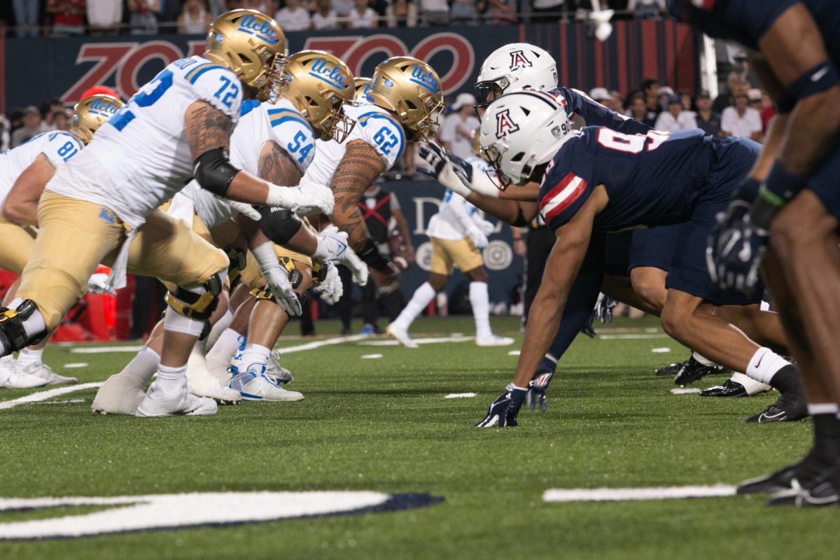 After the snap, the Arizona football teams defense clashed with UCLAs offense during the football game at Arizona Stadium in Tucson on Saturday, Nov. 4. The Bruins made gains in the second quarter with a last second touchdown, but Arizona ultimately won 27-10.