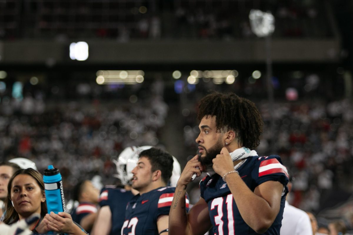 Deric English (31) of the Wildcats watches the action from the sidelines during the football game against the Bruins at Arizona Stadium in Tucson on Nov. 4. English is playing his first season as a freshman.
