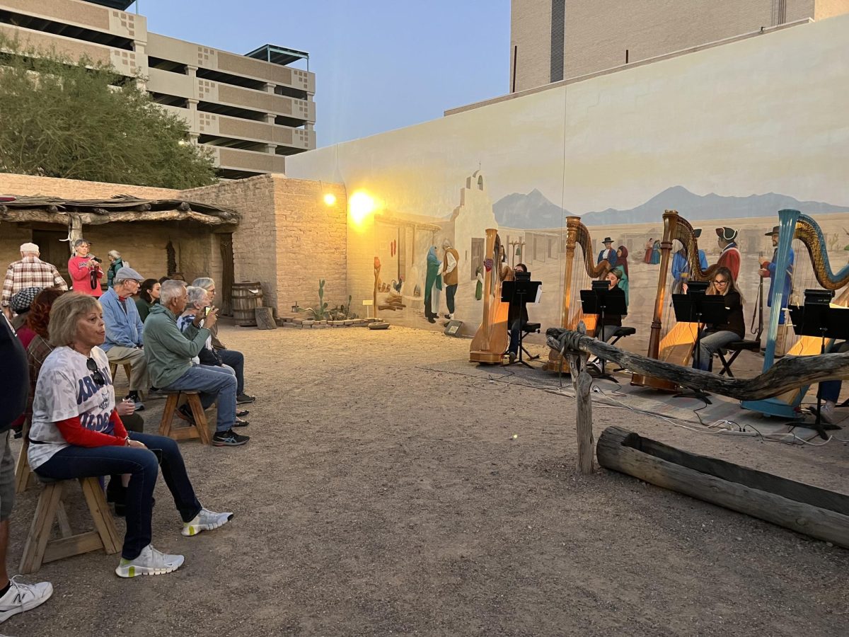 Participants watching another performance at one of the murals on Oct. 30 in the Presidio San Agustín del Tucson Museum. Students from the University of Arizona Fred Fox School of Music provided the musical performances for the event.