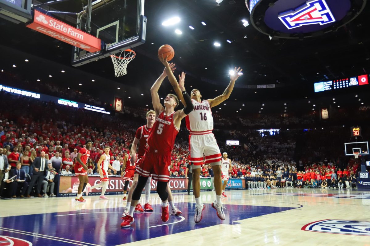 Keshad+Johnson+saves+the+ball+from+going+out+over+a+defender+in+the+opening+play+of+Arizonas+home+game+against+Wisconsin+on+Dec.+9.+Keshad+is+playing+his+first+season+at+Arizona+after+transferring+from+San+Diego+State.%0A