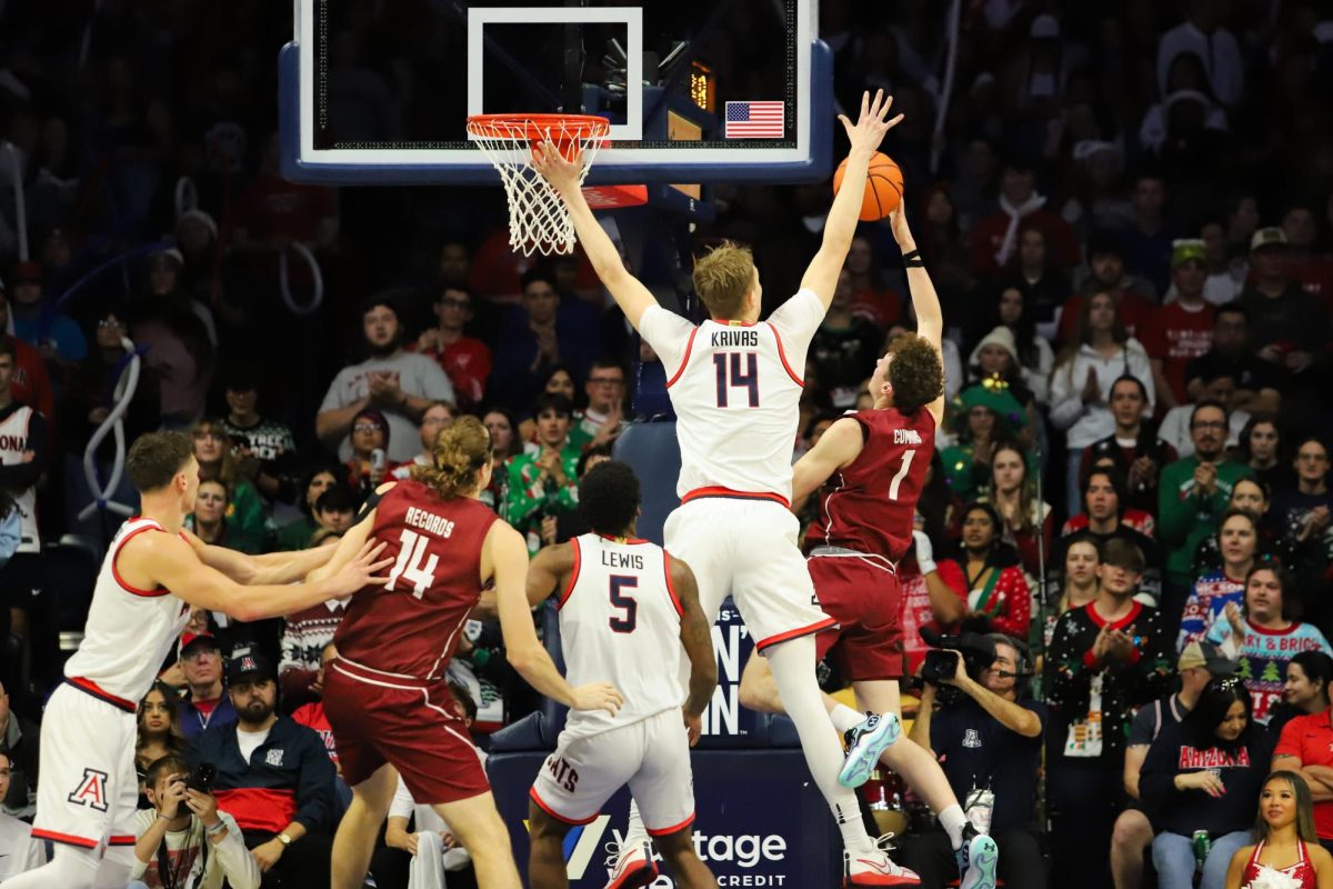 Motiejus Krivas extends in an attempt to block a Colgate shot in the beginning of the second half in McKale Center on Dec. 2. Arizona began the second half only five points ahead of Colgate, a lead that was extended almost immediately.
