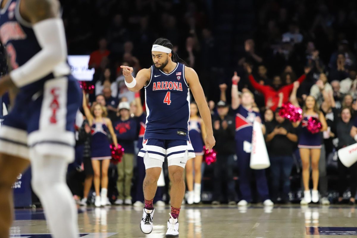 Kylan Boswell points to the bench after scoring a basket in the first half of Arizona's conference game against USC on Jan. 17 in McKale Center.
