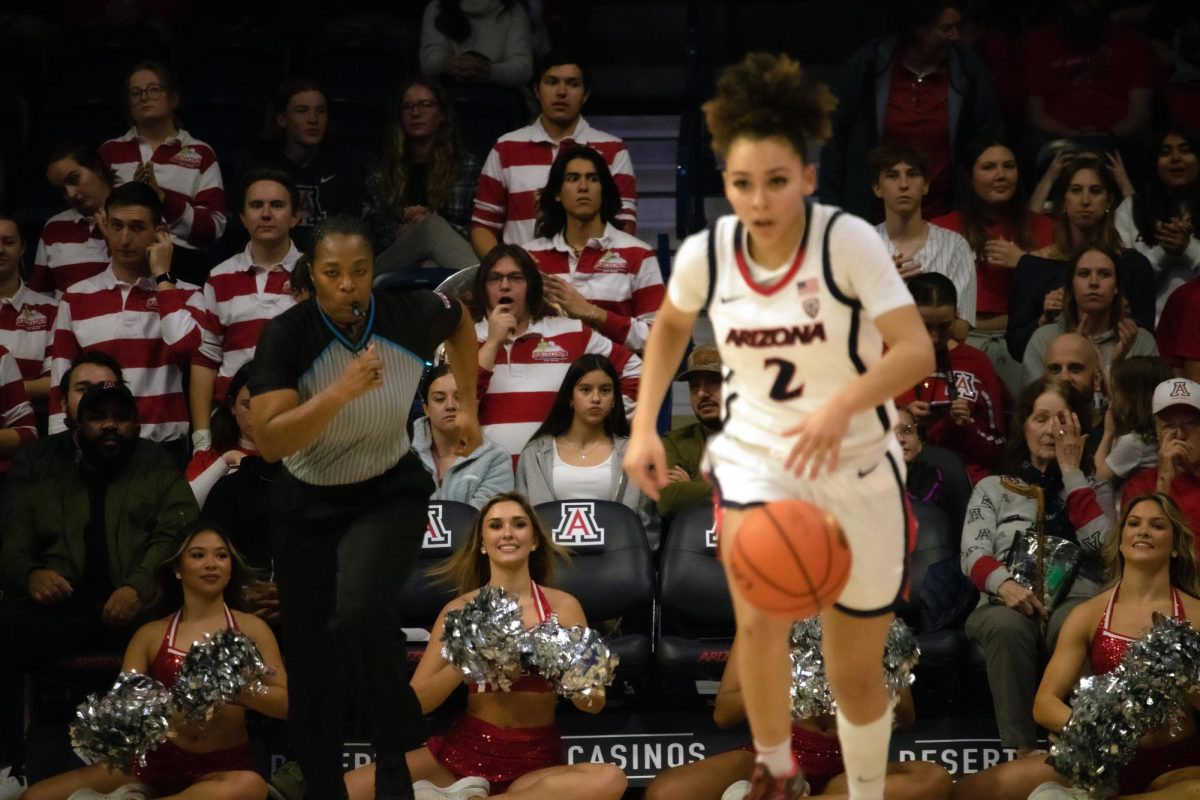 A+referee+follows+Jada+Williams+as+she+travels+up+the+court+in+a+game+against+Cal+in+McKale+Center+on+Jan.+26.+The+freshman+guard+scored+13+points+for+the+game.%0A