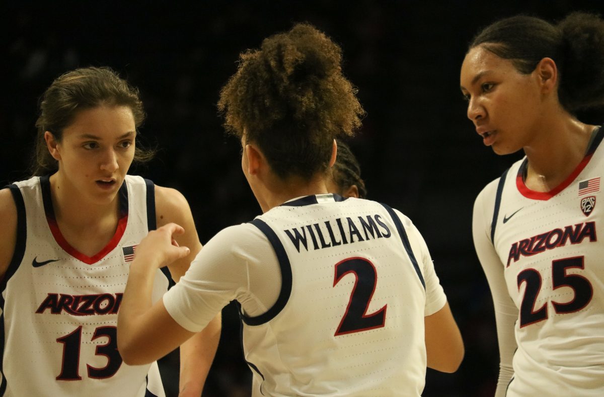 Helena Pueyo (13), Jada Williams (2) and Breya Cunningham (25) take a quick moment during their game against Cal on Jan. 26 in McKale Center. The Wildcats won 66-55.