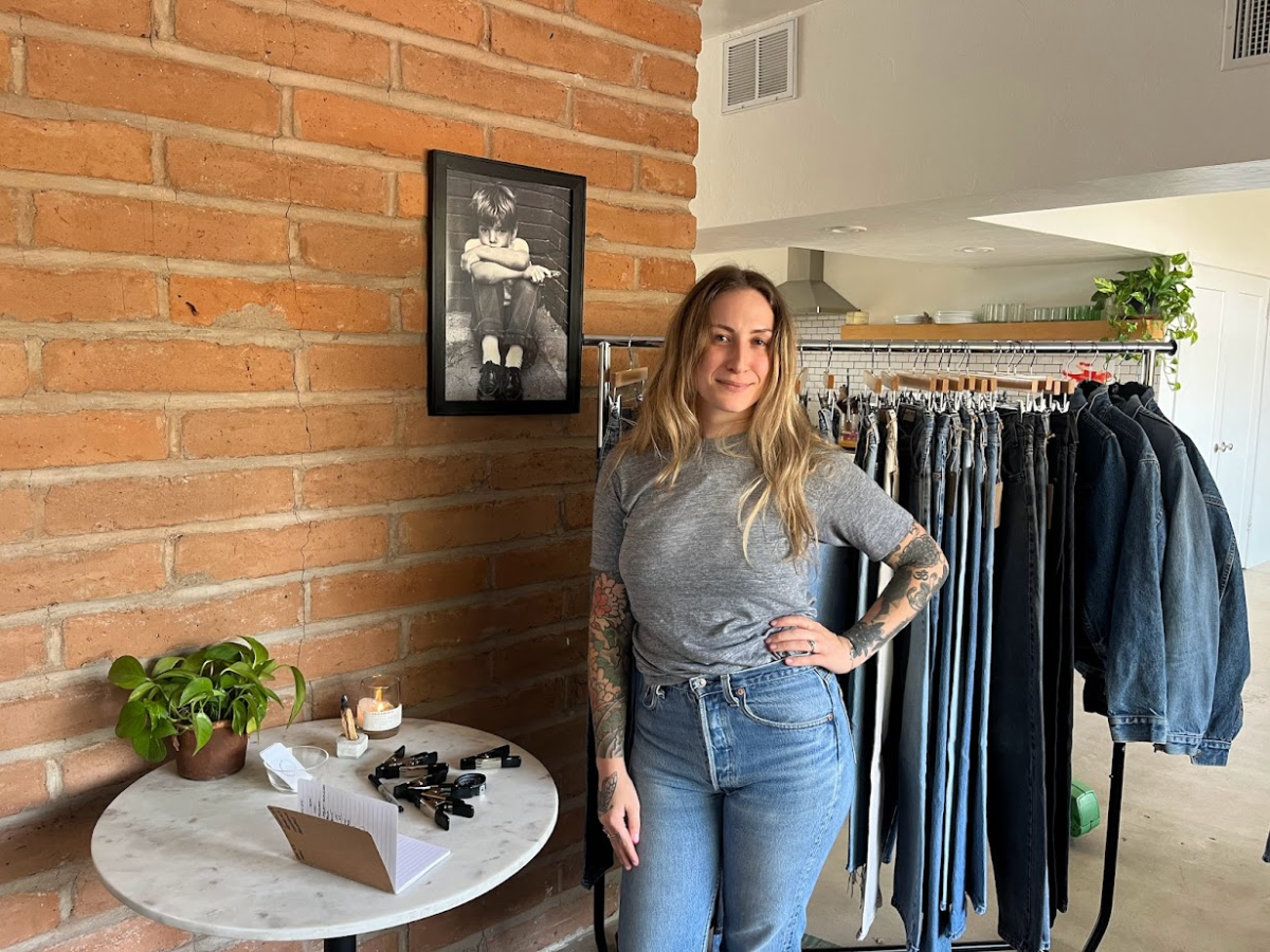 Kelly Durand in front of one of her two racks of Levis jeans and denim jackets.