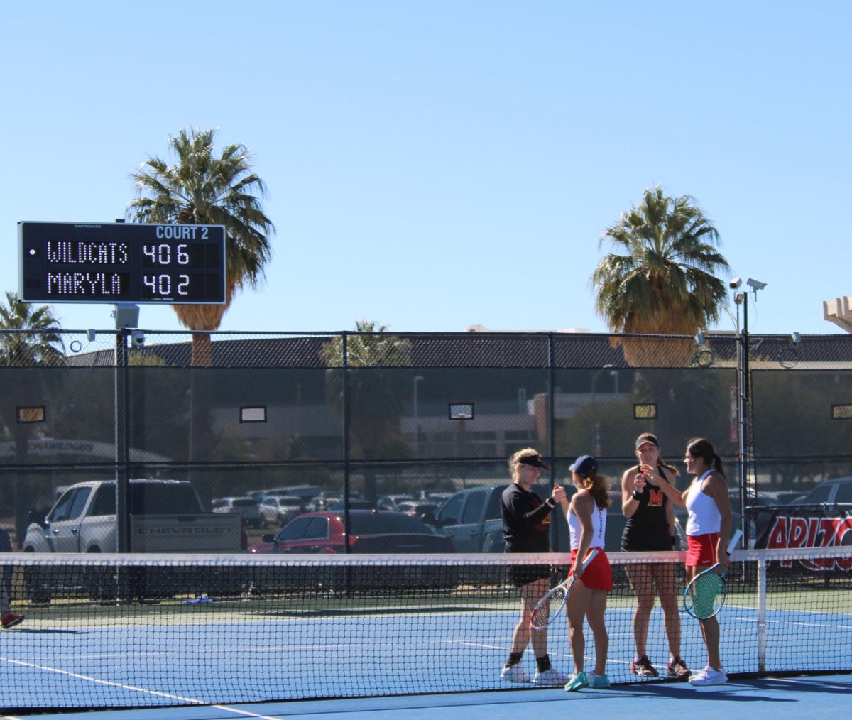 Womens tennis players shake hands with Maryland after a set on Feb. 4 at Robson Tennis Center. The Wildcats won with the overall match 4-2.
