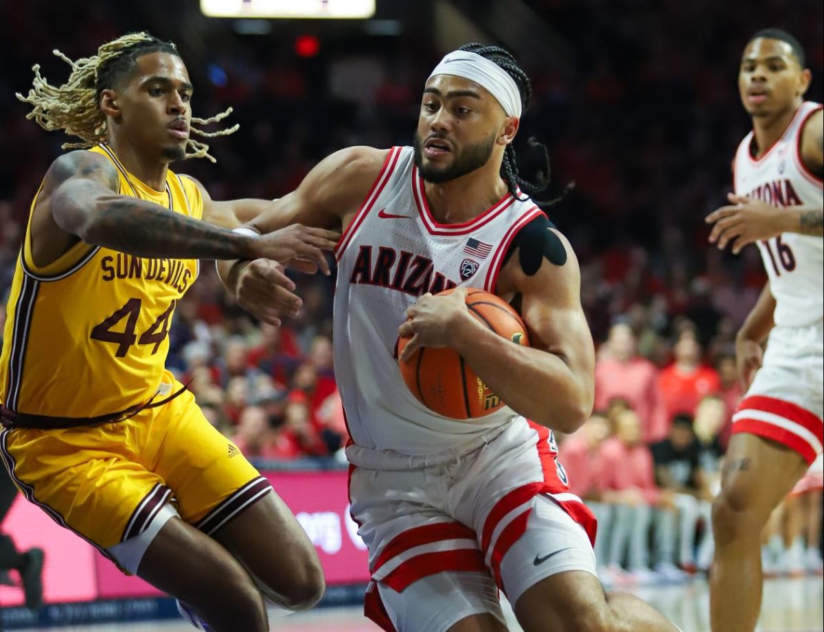 Kylan Boswell runs through contact towards the basket against ASU in McKale Center on Feb 17. Arizona managed to put up over 100 points in their home rivalry game.
