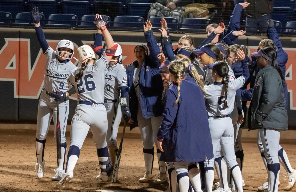Arizona softballs Sophomore Olivia DiNardo touches home plate while celebrating a home run with her teammates on Feb. 10 at Mike Candrea Field at Rita Hillenbrand stadium during the Candrea Classic tournament. 